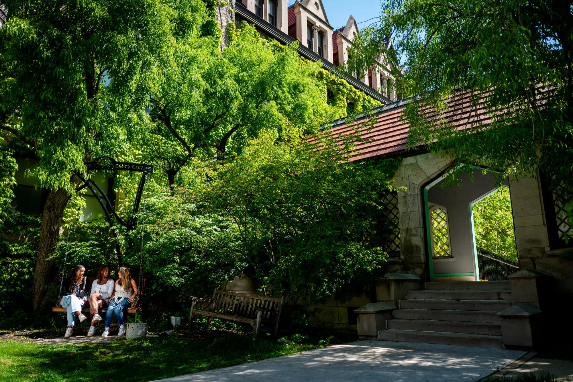 Students relaxing on campus under trees